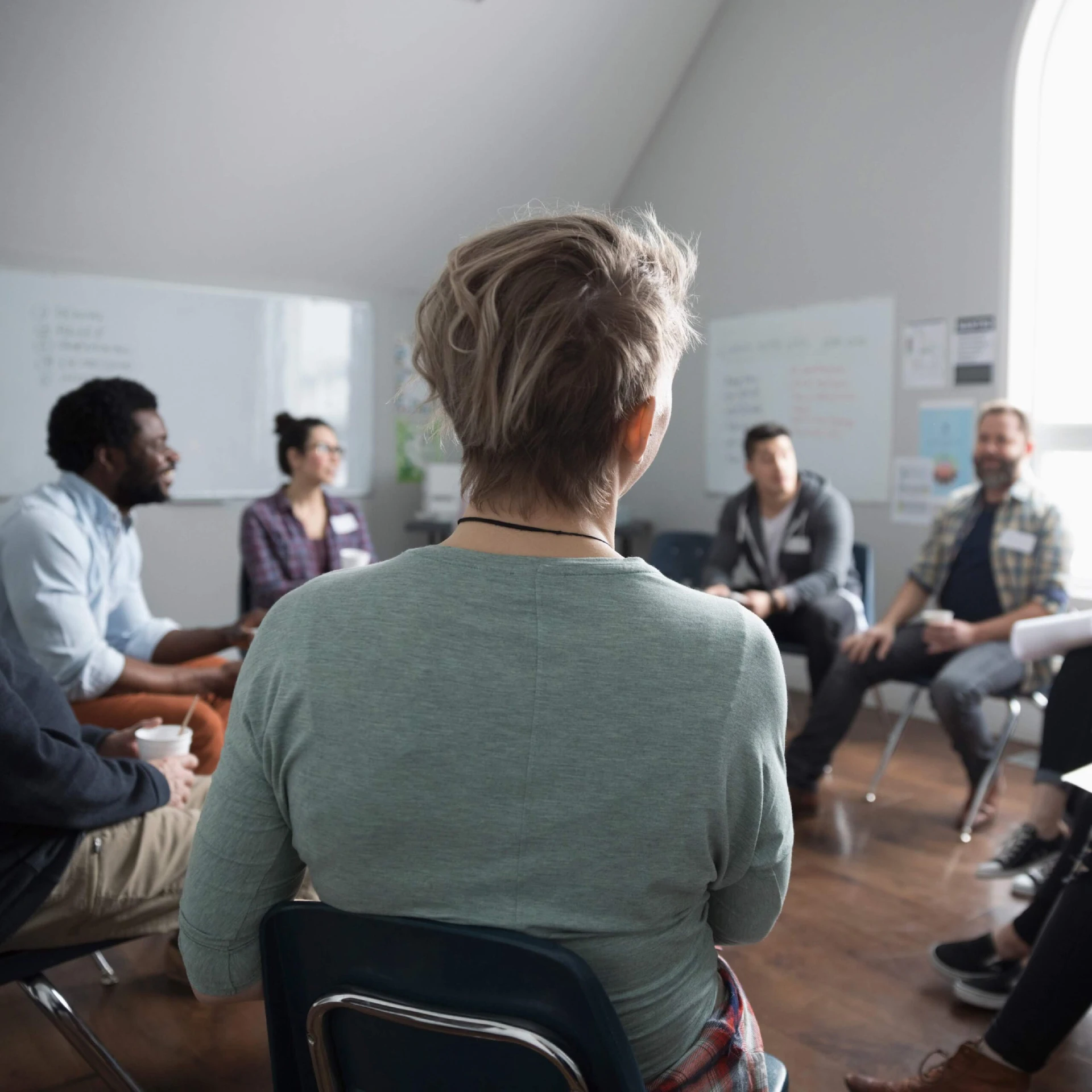 People talking in circle at support group in community center